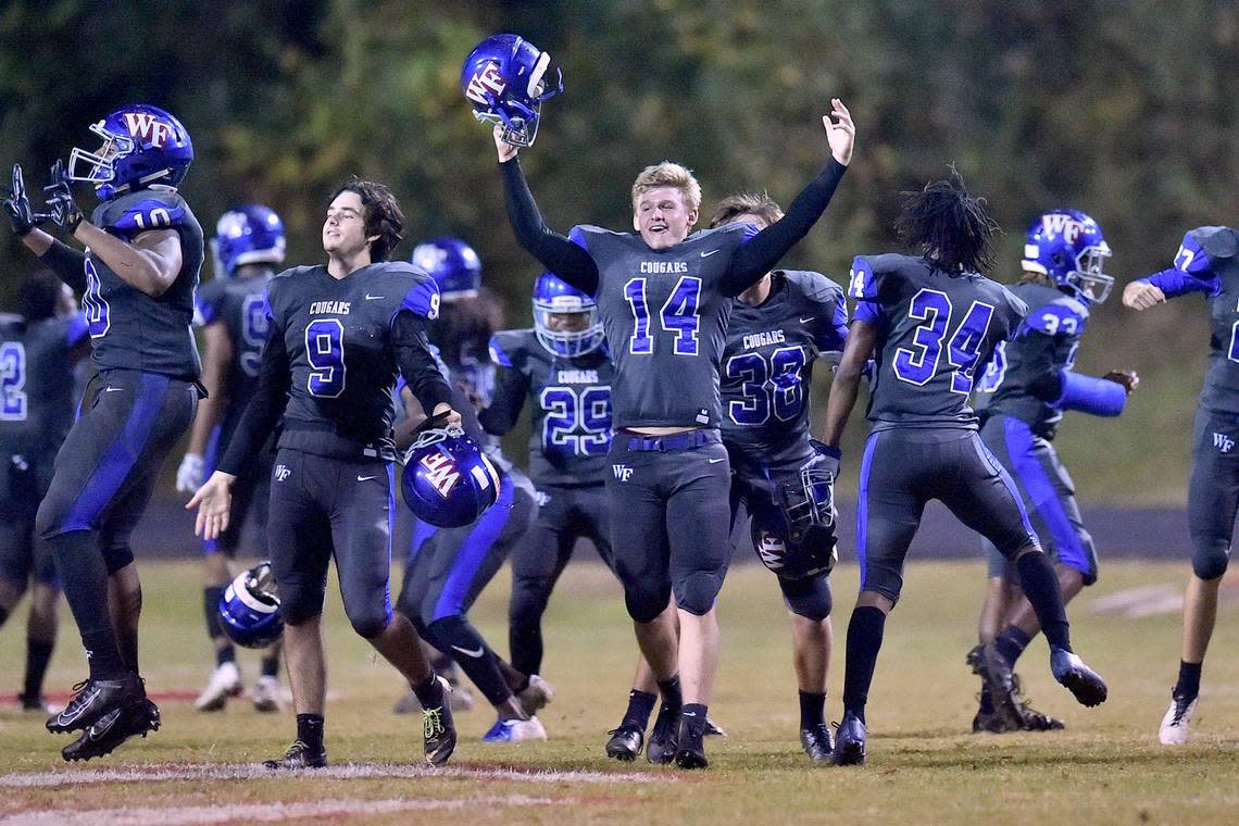 Wake Forest’s Grant Casey (14) celebrates with teammates after their overtime victory over Rolesville. The Rolesville Rams and the Wake Forest Cougars met in a regular season football game in Wake Forest, N.C. on October 25, 2019.