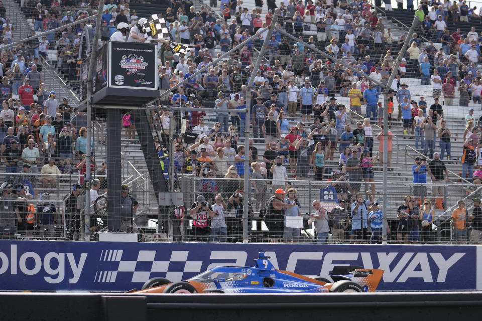 Scott Dixon takes the checkered flag to win an IndyCar auto race at World Wide Technology Raceway, Sunday, Aug. 27, 2023, in Madison, Ill. (AP Photo/Jeff Roberson)