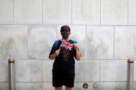 A man holds the British Union Jack flag during a protest outside British Consulate-general office in Hong Kong