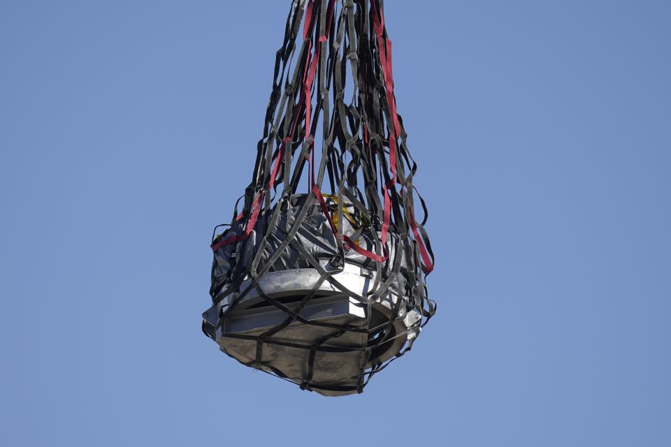 A helicopter delivers a space capsule carrying NASA’s first asteroid samples on Sunday, Sept. 24, 2023, to a temporary clean room at Dugway Proving Ground, in Utah. The Osiris-Rex spacecraft released the capsule following a seven-year journey to asteroid Bennu and back. | Rick Bowmer, Associated Press