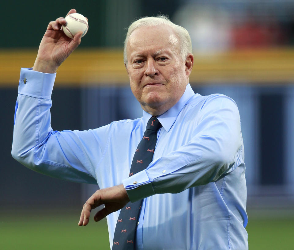 FILE - In this April 13, 2012, file photo, Atlanta Braves chairman emeritus: Bill Bartholomay throw out the ceremonial first pitch before a baseball game against the Milwaukee Brewers in Atlanta. Bartholomay, the former Braves owner who moved the team from Milwaukee to Atlanta in 1966, died Wednesday, March 25, 2020, at New York-Presbyterian Hospital, according to his daughter, Jamie. He was 91. Bartholomay sold the Braves to Ted Turner in 1976 but remained as chairman of the team's board of directors until 2003, when he assumed an emeritus role. (AP Photo/John Bazemore, File)