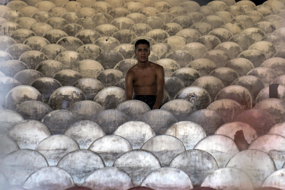 A young wrestler waits for his turn to wrestle during the 663rd annual Historic Kirkpinar Oil Wrestling championship, in Edirne, northwestern Turkey, Saturday, July 6, 2024. Wrestlers take part in this "sudden death"-style traditional competition wearing only a pair of leather trousers and a good slick of olive oil. The festival is part of UNESCO's List of Intangible Cultural Heritages. (AP Photo/Khalil Hamra)