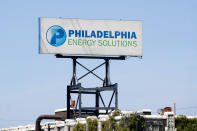 A sign for Philadelphia Energy Solutions stands at the refining complex in Philadelphia, Wednesday, June 26, 2019. The owner of the largest oil refinery complex on the East Coast is telling officials that it will close the facility after a fire last week set off explosions and damaged the facility. Philadelphia Mayor Jim Kenney said in a statement Wednesday that Philadelphia Energy Solutions had informed him of its decision to shut down the facility in the next month. The more than 1,000 workers there will be impacted, the mayor said. (AP Photo/Matt Rourke)