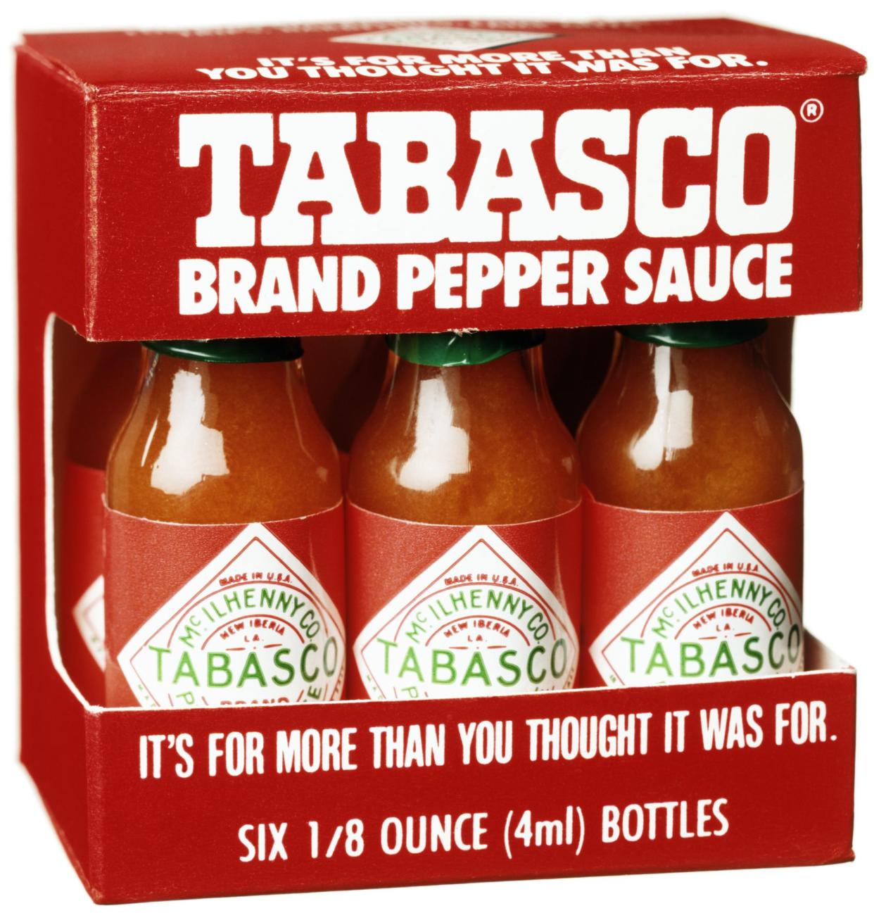 Truro, MA, USA - January 5, 2012. Three bottles of Tabasco red pepper sauce against white background.Tabasco sauce is the brand name for a hot sauce produced by US-based McIlhenny Company of Avery Island, Louisiana.