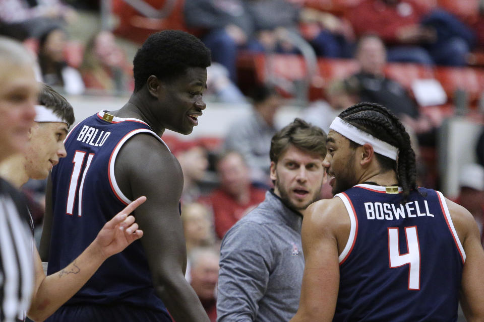 Arizona guard Kylan Boswell (4), center Oumar Ballo (11) and guard Kerr Kriisa, left, walk on the court near the end of the second half of the team's NCAA college basketball game against Washington State, Thursday, Jan. 26, 2023, in Pullman, Wash. Arizona won 63-58. (AP Photo/Young Kwak)