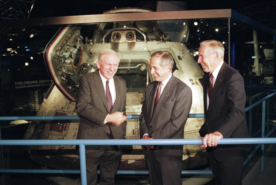 FILE - From left to right, Apollo 8 astronauts Frank Borman, William Anders and James Lovell Jr. gather near their spacecraft at the Museum of Science and Industry in Chicago, Ill., where the astronauts are celebrating the 25th anniversary of their six-day mission to enter the lunar atmosphere and orbit the moon. Dec. 10, 1993. Retired Maj. Gen. Anders was killed Friday, June 7, 2024, when the plane he was piloting alone plummeted into the waters off the San Juan Islands in Washington state. He was 90. (AP Photo/John Swart, File)