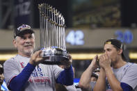 Texas Rangers manager Bruce Bochy holds up the trophy after Game 5 of the baseball World Series against the Arizona Diamondbacks Wednesday, Nov. 1, 2023, in Phoenix. The Rangers won 5-0 to win the series 4-1. (AP Photo/Godofredo A. Vásquez)