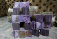 FILE PHOTO: Syrian pounds are pictured inside an exchange currency shop in Azaz