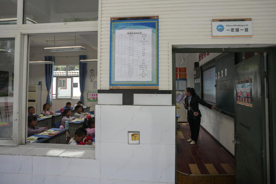 A teacher teaches alphabets in a first-grade class at the Shangri-La Key Boarding School during a media-organized tour in Dabpa county, Kardze Prefecture, Sichuan province, China on Sept. 5, 2023. (AP Photo/Andy Wong)