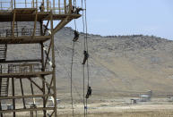 FILE - In this July 17, 2021 file photo, Afghan Army Special forces take part in a training exercise after a three-month training program at the Kabul Military Training Center in Kabul, Afghanistan. The US and NATO have promised to pay $4 billion a year until 2024 to finance Afghanistan’s military and security forces, which are struggling to contain an advancing Taliban. Already since 2001, the U.S. has spent nearly $89 billion to build, equip and train the forces. (AP Photo/Rahmat Gul, File)