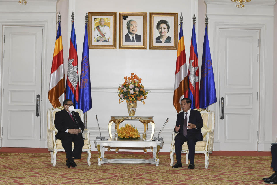 In this photo provided by An Khoun Sam Aun/National Television of Cambodia, Cambodian Prime Minister Hun Sen, right, talks with Myanmar Foreign Minister Wunna Maung Lwin at Peace Palace in Phnom Penh, Cambodia, Tuesday, Dec. 7, 2021. Wunna Maung Lwin is on a two-day official visit to Cambodia. (An Khoun SamAun/National Television of Cambodia via AP)