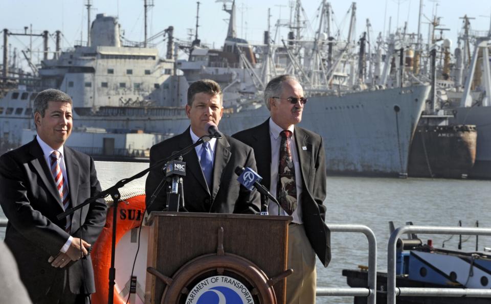 John Porcari speaks in front of ships outside San Francisco.