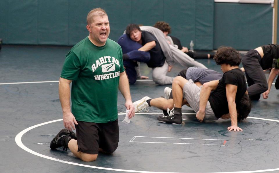 Raritan High School head wrestling coach Rob Nucci (kneeling) is in his final season as the Rockets' head coach.