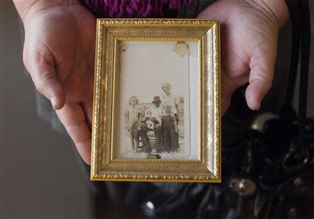 Terri Evans of Manning, South Carolina holds a photograph taken around 1943 that shows members of her family including murder victim Mary Emma Thames (far left) at a hearing to reopen the case of George Stinney, Jr., in Sumter, South Carolina, January 21, 2014. REUTERS/Randall Hill