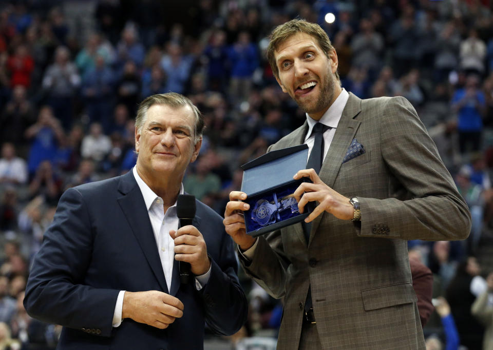 Dallas Mavericks player Dirk Nowitzki makes a face as he is presented with the key to the city of Dallas by Dallas Mayor Mike Rawlings, left, during halftime of an NBA basketball game against the Brooklyn Nets, in Dallas, Wednesday, Nov. 21, 2018. (AP Photo/Michael Ainsworth)