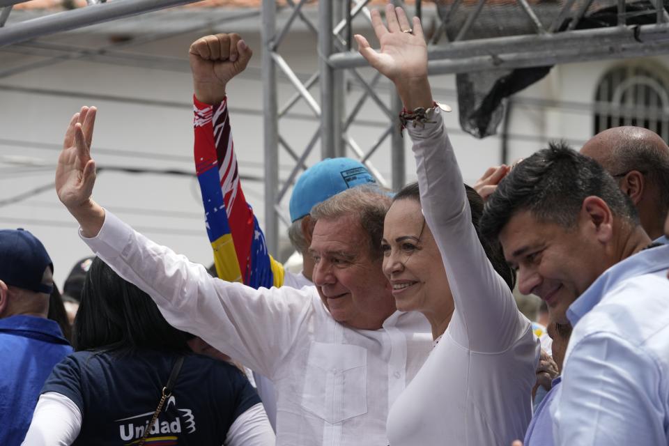 Venezuelan presidential candidate Edmundo González Urrutia, left center, and opposition leader Mariana Corina Machado greet supporters at the launch of his campaign for the upcoming election, in La Victoria, Venezuela, Saturday, May 18, 2024. (AP Photo/Ariana Cubillos)