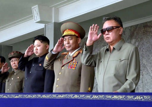 North Korean leader Kim Jong-Il (R) and his son Kim Jong-un (2nd L) appearing at a military parade in Pyongyang on September 9, 2011. Jong-Un was born to the leader's third wife, Japan-born ethnic Korean dancer Ko Yong-Hi, who is believed to have died of breast cancer in 2004