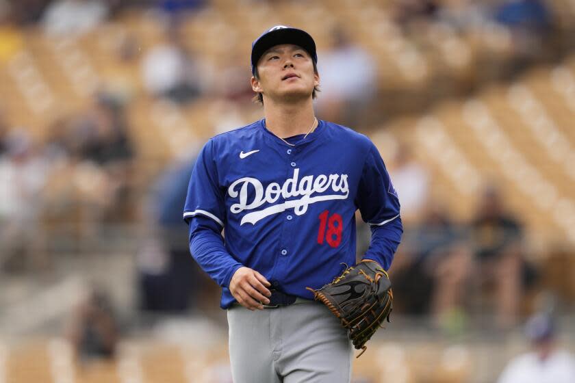 Los Angeles Dodgers starting pitcher Yoshinobu Yamamoto reacts after a single by Chicago White Sox' Dominic Fletcher during the first inning of a spring training baseball game in Phoenix, Wednesday, March 6, 2024. (AP Photo/Ashley Landis)