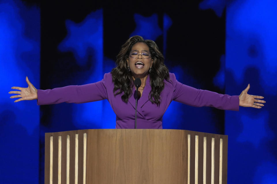 Oprah Winfrey spreads her arms wide as she speaks at the Democratic National Convention.