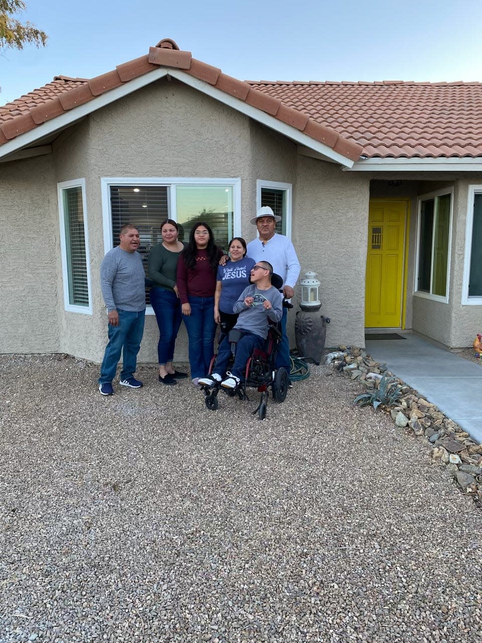 Juan Carlos López Flores (in hat) and his wife, Maria Chavarría, bought their first house in Las Vegas. He and his brother's family will live in the house together.