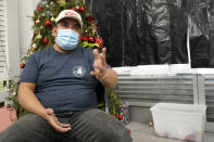 Gustavo Ajche, 38, who has three jobs, gestures after watching Joe Biden's presidential inauguration on TV with other immigrants at the offices of the Workers Justice Center, Wednesday, Jan. 20, 2021, in the Sunset Park neighborhood in New York. Atche has been in the United States since 2004. His wife is in the United States but his children are back in Guatemala while he and his wife pay for their college education there. Atche works construction, delivers food for food delivery applications, and works helping his community at a food pantry in Brooklyn. (AP Photo/Kathy Willens)