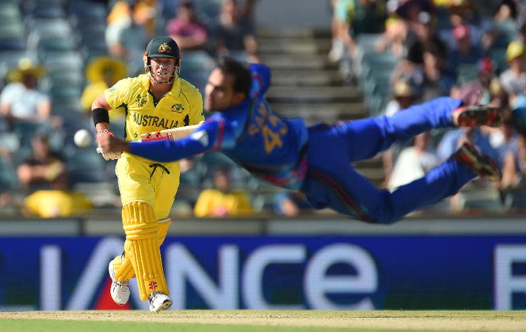 Afghanistan's Samiullah Shinwari makes an unsuccessful attempt to catch the ball from Australia's David Warner during their World Cup match on March 4, 2015