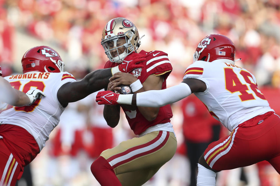 Kansas City Chiefs linebacker Omari Cobb, right, reaches to San Francisco 49ers quarterback Trey Lance, middle, as defensive tackle Khalen Saunders approaches during the first half of an NFL preseason football game in Santa Clara, Calif., Saturday, Aug. 14, 2021. (AP Photo/Jed Jacobsohn)