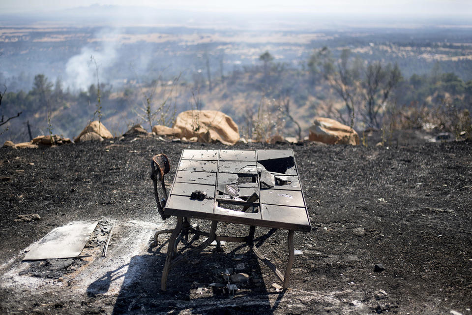 <p>A charred desk rests outside a residence after a wildfire burned through the property on Saturday, July 8, 2017, near Oroville, Calif. The fast-moving wildfire in the Sierra Nevada foothills destroyed structures, including homes, and led to several minor injuries, fire officials said Saturday as blazes threatened homes around California during a heat wave. (AP Photo/Noah Berger) </p>