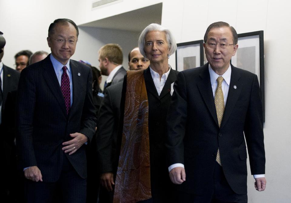 International Monetary Fund (IMF) Managing Director Christine Lagarde, center, accompanied by World Bank President Jim Yong Kim, left, and UN Secretary General Ban Ki-moon, meet with reporters during the World Bank Group- International Monetary Fund Spring Meetings in Washington, Friday, April 11, 2014. ( AP Photo/Jose Luis Magana)