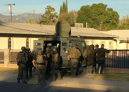 A police SWAT team searches a church during a manhunt after a mass shooting in San Bernardino, California December 2, 2015. REUTERS/Mike Blake