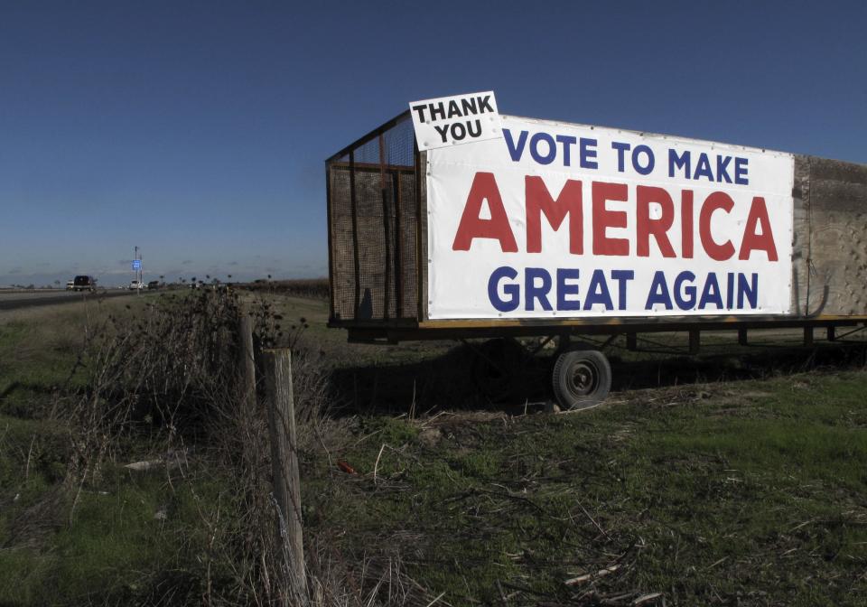 This Dec. 17, 2016 photo shows a Donald Trump campaign sign along a highway near Los Banos, Calif. A California farmer says Donald Trump's campaign vow to deport millions of immigrants who are in the country illegally pushed him into buying more equipment, cutting the number of workers he’ll need during the next harvest. Others in California's farming industry say Trump's tough campaign talk targeting immigrants in the country illegally, including a vast number of farmworkers, spurred them into action, too. (AP Photo/Scott Smith)