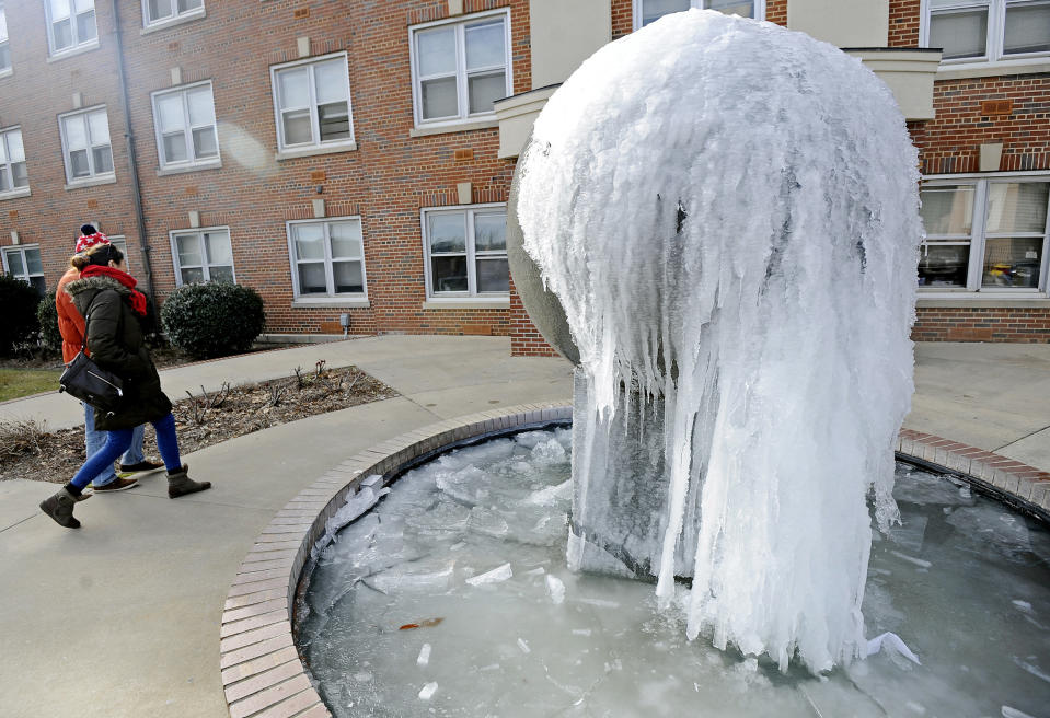 Students walk past a frozen fountain at Troy University in Troy, Ala., Tuesday, Jan. 7, 2014. (AP Photo/The (Troy) Messenger, Thomas Graning)