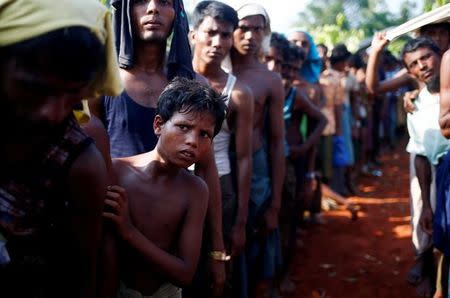 A Rohingya refugee boy looks on as he stands in a queue to receive relief supplies given by local people in Cox’s Bazar, Bangladesh September 16, 2017. REUTERS/Mohammad Ponir Hossain TPX