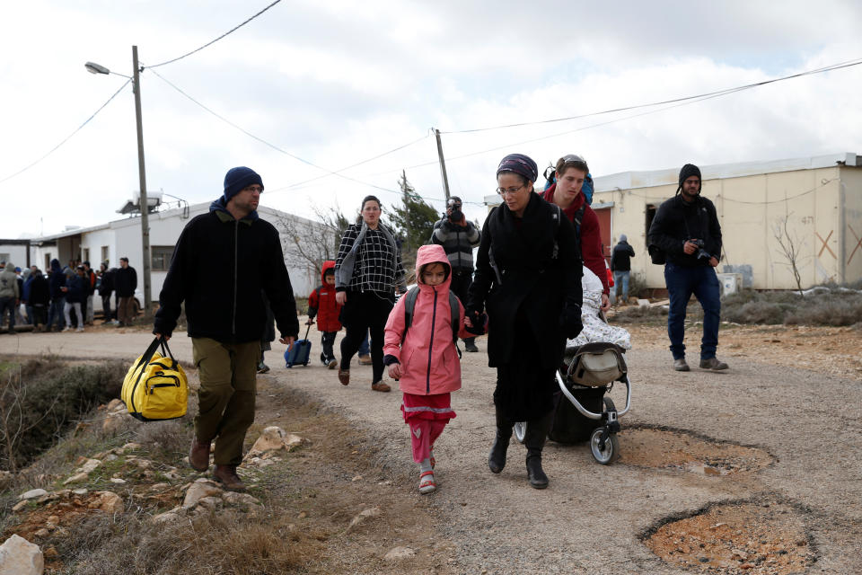 An Israeli settler family leave during an eviction by Israeli police.