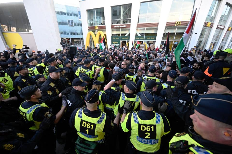 Demonstrators face police during a protest against Israel’s participation ahead of the final (AP)