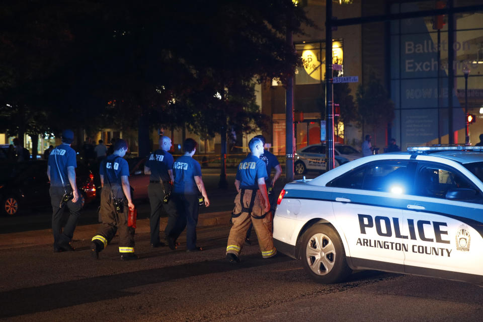 Emergency responders walk outside where a shooting was reported at Ballston Quarter mall in Arlington, Va., Saturday, Sept. 14, 2019. Authorities said they have found no evidence that a shooting occurred at a movie theater that is part of the mall. Reports of a shooting had prompted panic and a large police presence Saturday night. (AP Photo/Patrick Semansky)