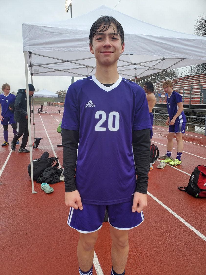 Shasta freshman midfielder/forward Gavin Copeland poses for the camera after getting drenched by the rain while competing against Lassen at Foothill High School on Saturday, Dec. 3, 2022.