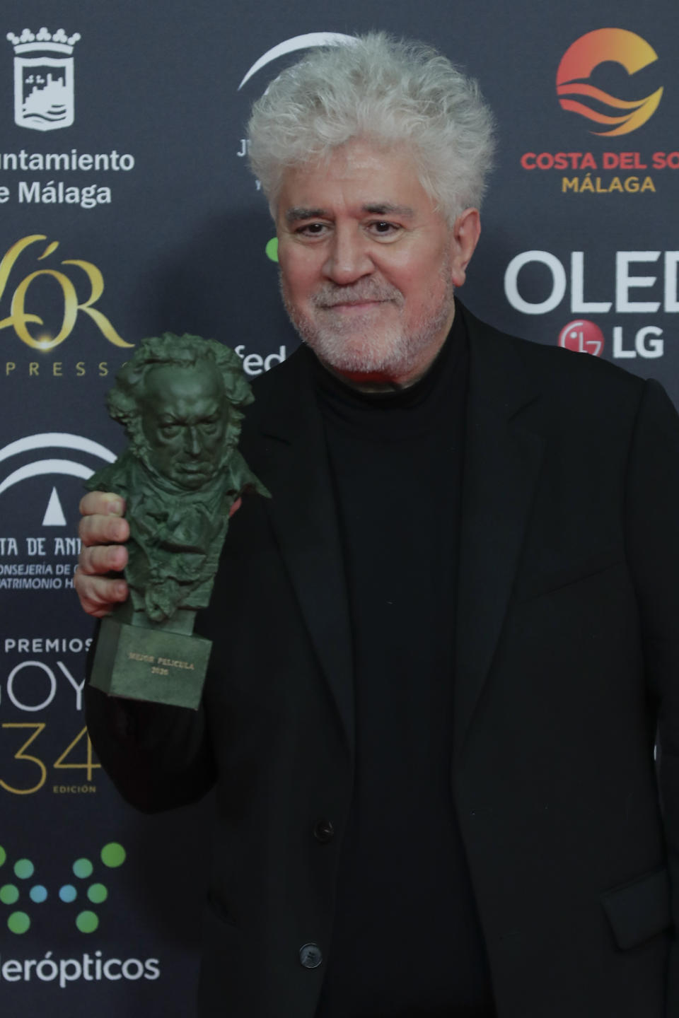 Spanish film director Pedro Almodovar poses with his trophy after winning the best film award for "Dolor y gloria" during the Goya Film Awards Ceremony in Malaga, southern Spain, early Sunday, Jan. 26, 2020. The annual Goya Awards are Spain's main national film awards. (AP Photo/Manu Fernandez)