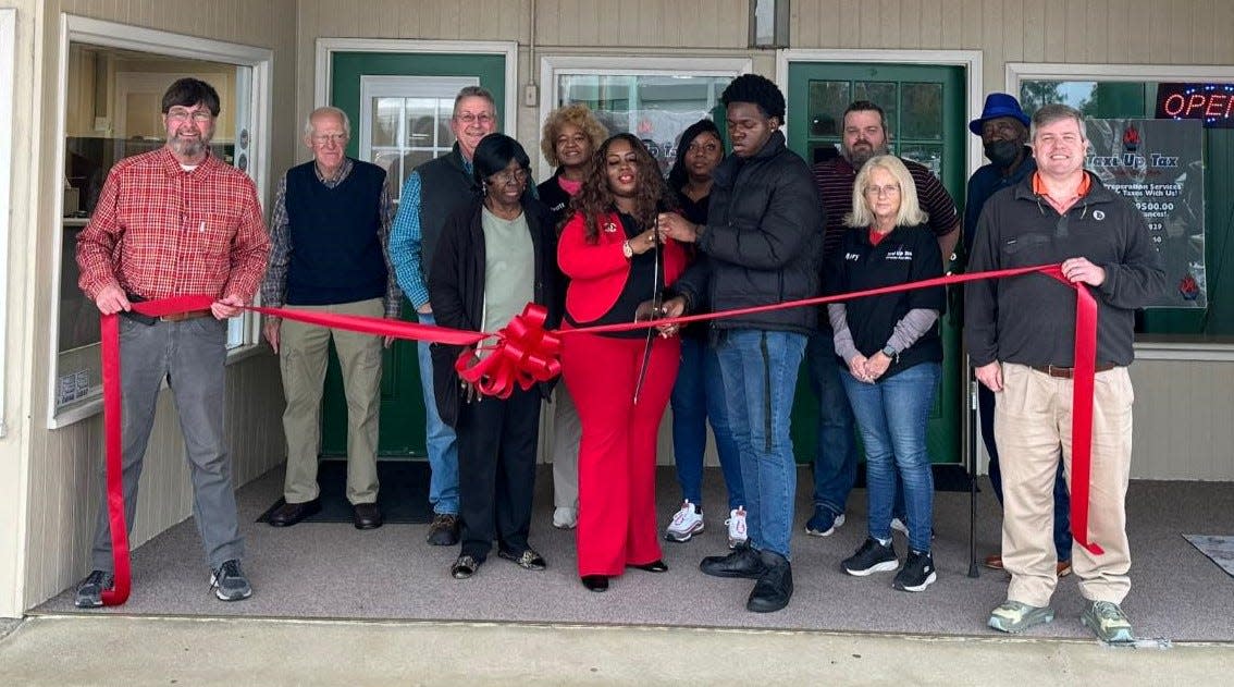 Virginia Hall cuts the ribbon officially opening her new Wrens location of Taxi Up Tax Services located at 217B Broad Street.