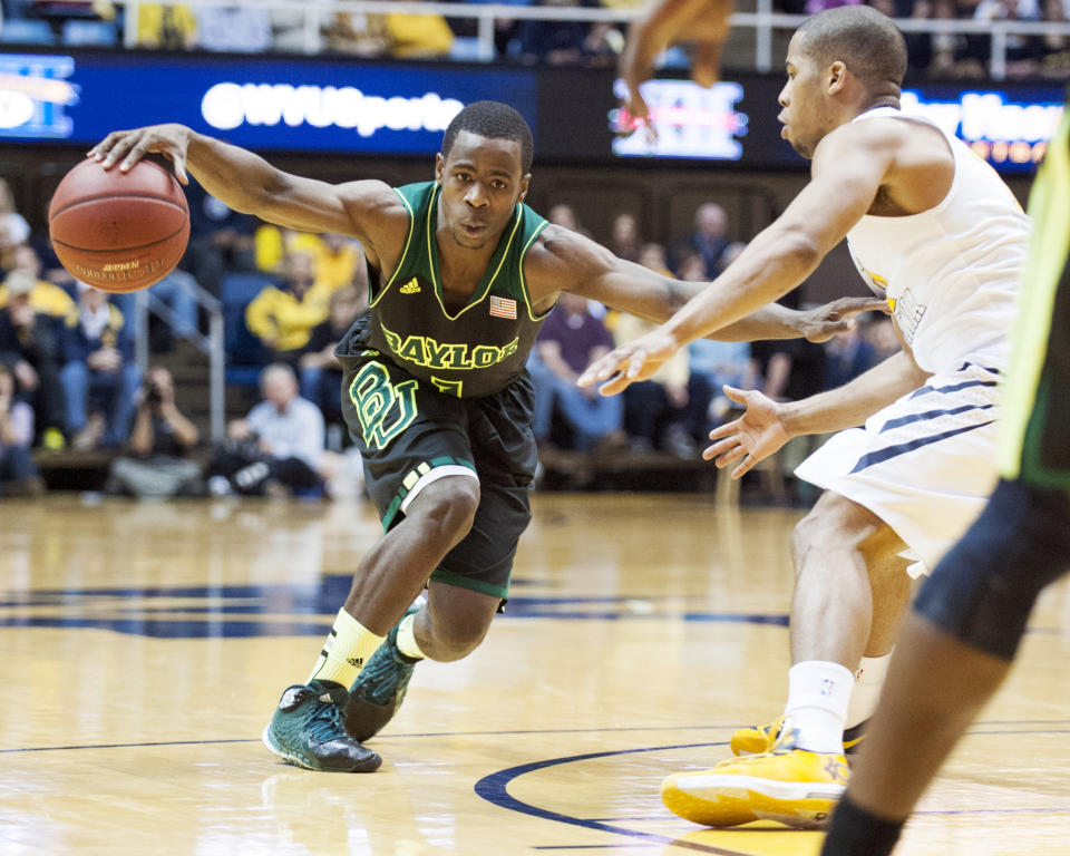 Baylor's Kenny Chery, left, drives by West Virginia's Gary Browne during the second half of an NCAA college basketball game Saturday, Feb. 22, 2014, in Morgantown, W.Va. Baylor won 88-75. (AP Photo/Andrew Ferguson)