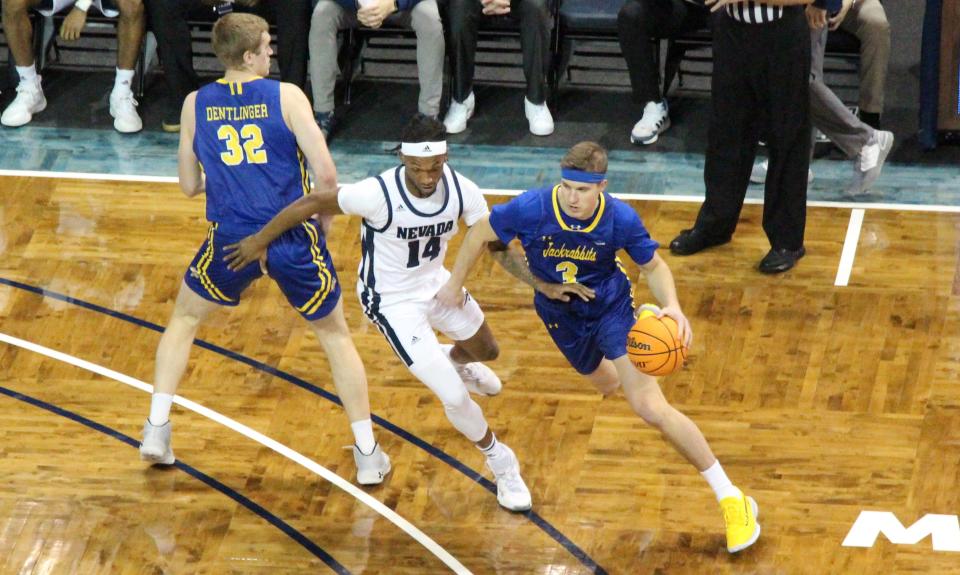 SDSU's Baylor Scheierman drives around Nevada's Tre Coleman Monday night in the Crossover Classic at the Sanford Pentagon