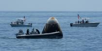 Support teams and curious recreational boaters arrive at the SpaceX Crew Dragon Endeavour spacecraft shortly after it landed with NASA astronauts Robert Behnken and Douglas Hurley onboard in the Gulf of Mexico