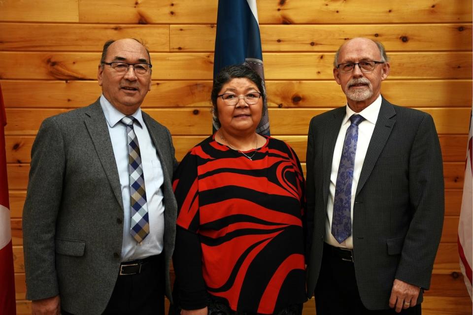 Commissioners James Igloliorte, Anastasia Qupee and Mike Devine stand at the first hearings of the Inquiry in February, 2023. 