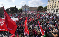 Demonstrators take part in a march organized by Italy's main labor unions, in Rome's St. John Lateran square, Saturday, Oct. 16, 2021. The march was called a week after protesters, armed with sticks and metal bars, smashed their way into the headquarters of CGIL, a left-leaning union, and trashed its office, during a demonstration to protest a government rule requiring COVID-19 vaccines or negative tests for workers to enter their offices. (AP Photo/Andrew Medichini)