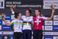Ellen van Dijk of the Netherlands, centre, reacts on the podium after winning the women's individual time trial at the world road cycling championships in Wollongong, Australia, Sunday, Sept. 18, 2022. Grace Brown, left, of Australia, was second and Switzerland's Marlen Reusser, right, was third. (AP Photo/Rick Rycroft)