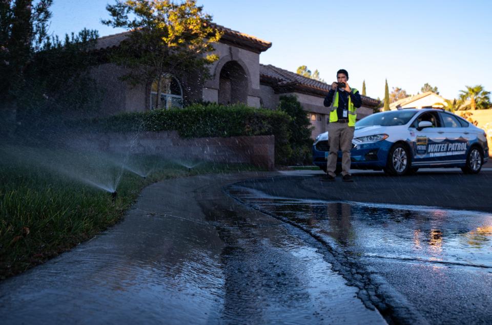 Water waste investigator Cameron Donnarumma of Las Vegas Valley Water District documents a violation at a home in southwest Las Vegas on Sept. 27, 2022. Donnarumma issued a warning for water running off property and down the street.