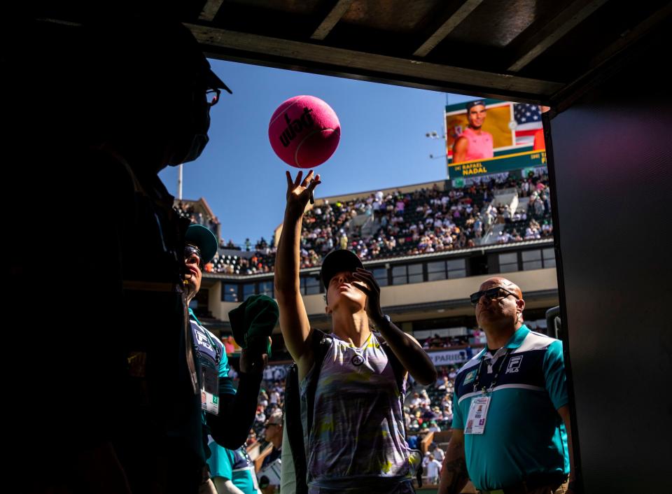 Iga Swiatek of Poland signs autographs for fans as she exits the stadium after winning the WTA singles title at the BNP Paribas Open at the Indian Wells Tennis Garden in Indian Wells, Calif., Sunday, March 20, 2022. 