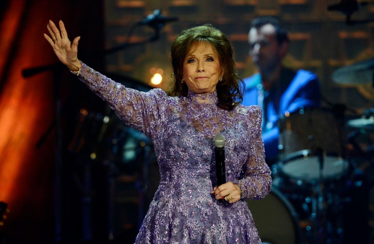 FILE - Loretta Lynn waves to the crowd after performing during the Americana Music Honors and Awards show Wednesday, Sept. 17, 2014, in Nashville, Tenn. Lynn, the Kentucky coal minerâ€™s daughter who became a pillar of country music, died Tuesday at her home in Hurricane Mills, Tenn. She was 90. (AP Photo/Mark Zaleski, File)