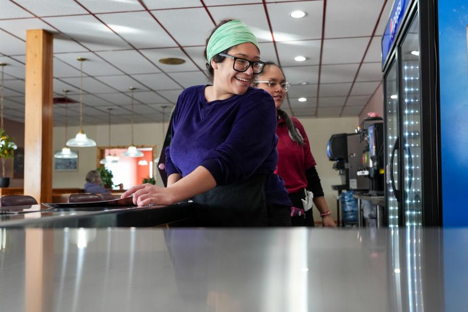 Waitress Diana Negrete, left, smiles with Mariana Gonzalez at Cronk's Café.
