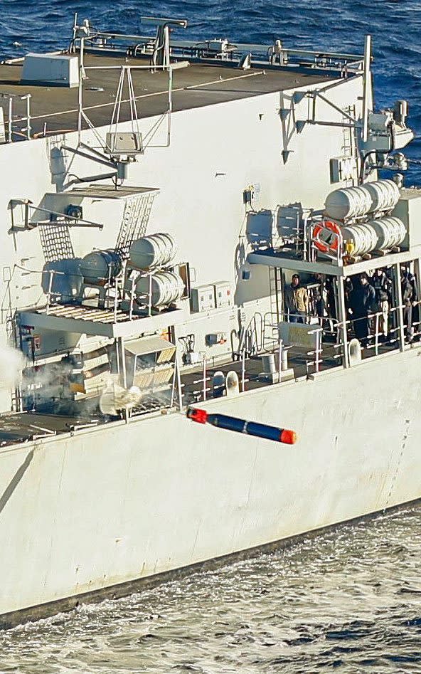 HMS Portland fires an exercise torpedo from her Magazine Torpedo Launching System